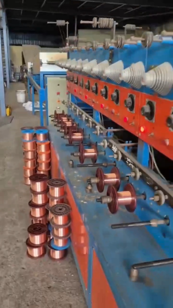 Copper bobbins feeding a bunching machine on the Lahotiraj Metals plant floor in Bhilwara